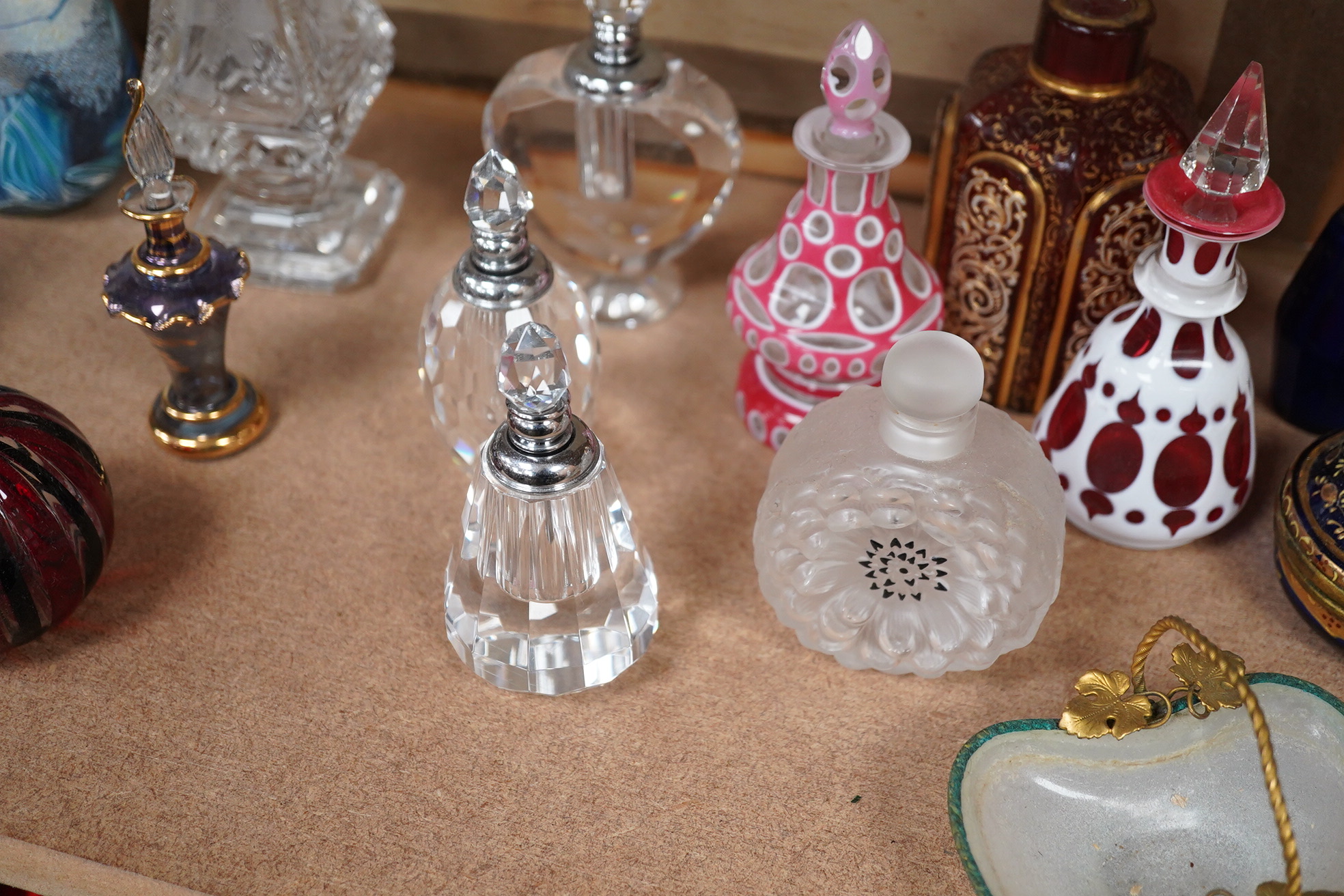 A collection of various glass scent bottles including a Lalique flower scent bottle and Bohemian examples, tallest 20.5cm. Condition - fair, some stoppers stuck